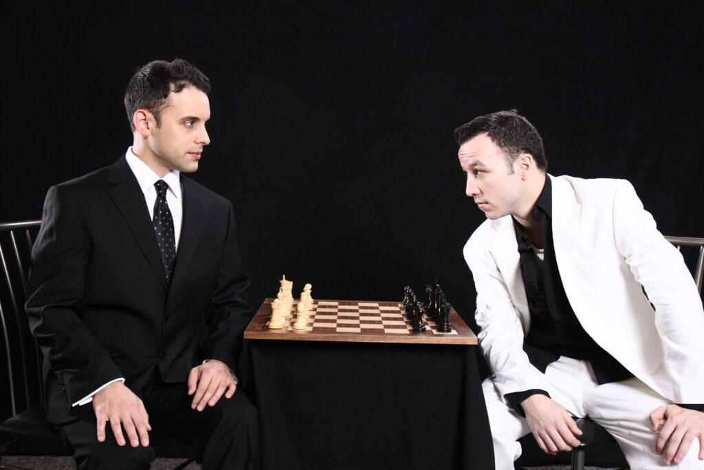 2 men staring down over a chessboard